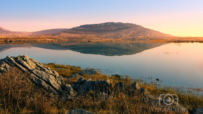 Mullaghmore mountain reflected in Lake at Burren National Park in county Clare, Ireland, nature background